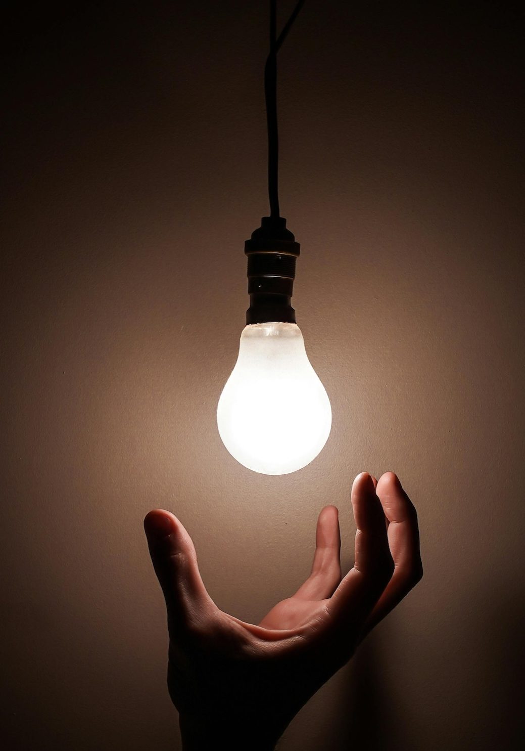 person grabbing a lightbulb